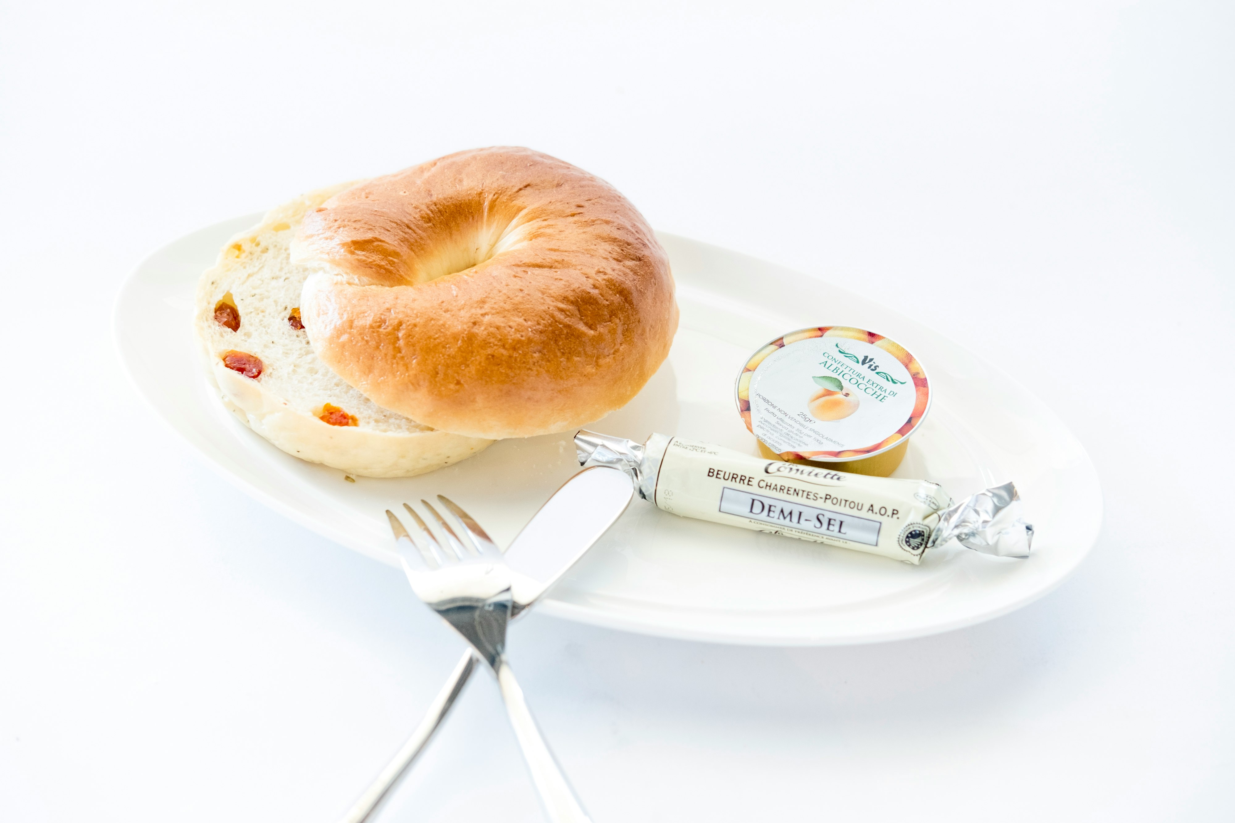 bread on white plate with fork and table knife